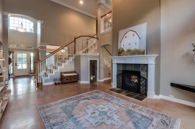 View from living area towards front door revealing front stairway access and foyer | Image 34