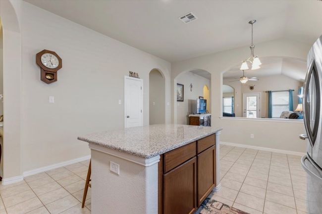 Looking at dining area from stove in kitchen. | Image 10
