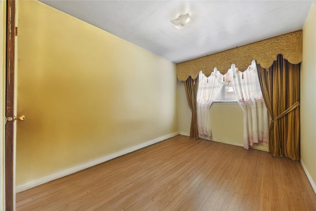 Unfurnished room with hardwood / wood-style flooring and baseboards | Image 19