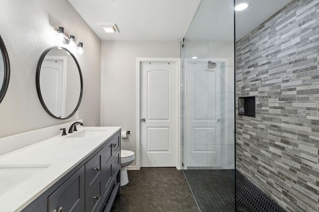 Fully updated primary bathroom with dual sinks, huge walk in shower and walk in closet | Image 15