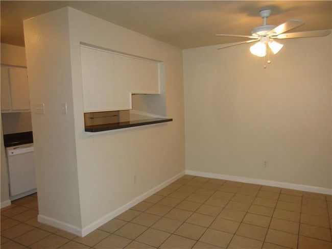Tiled empty room with ceiling fan | Image 6