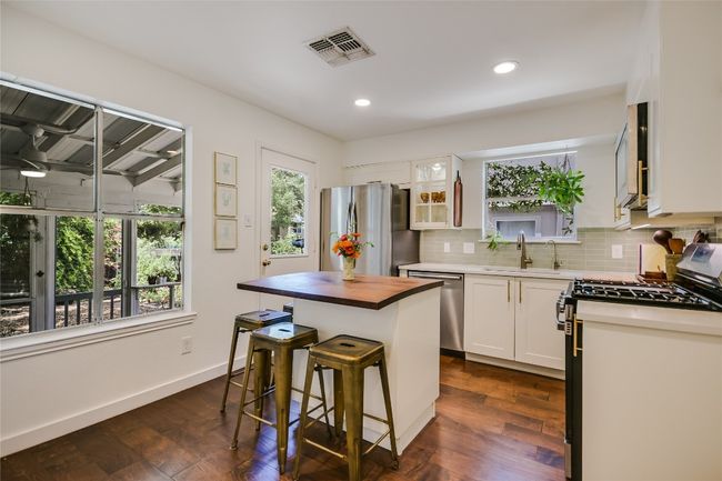 Fully remodeled kitchen with contemporary cabinets, tile backsplash, large sink, and stainless appliances. | Image 8