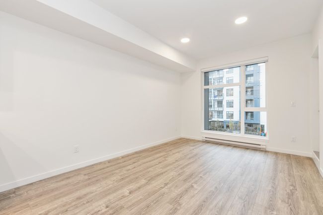 Empty room featuring baseboard heating, light wood-style floors, baseboards, and recessed lighting | Image 4