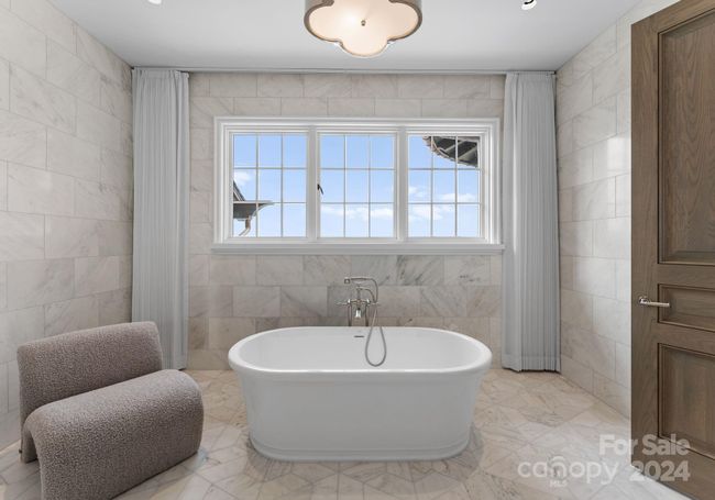 Upper-level secondary En-suite features two vanities, a soaker tub, and a separate shower room. | Image 29