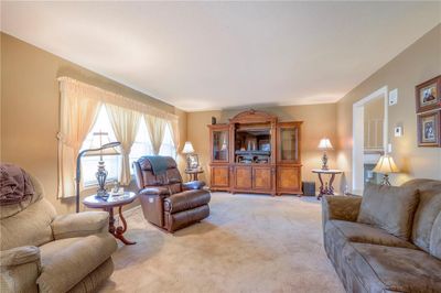 Living room featuring light colored carpet, lots of sunlight | Image 3