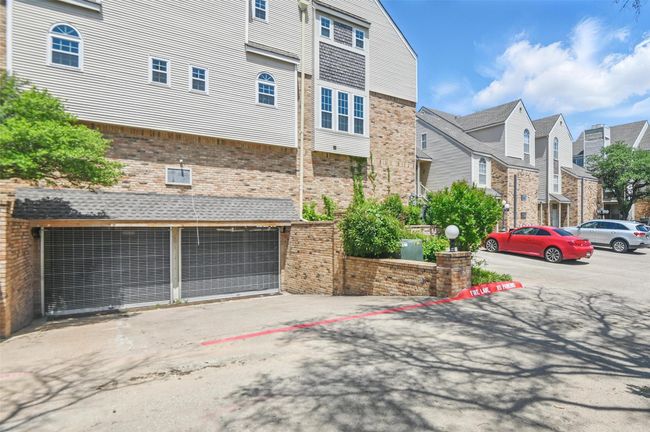 View of building exterior featuring a garage | Image 26
