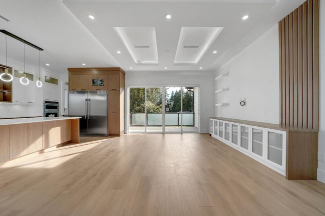 Unfurnished living room featuring light wood-style floors and recessed lighting | Image 7