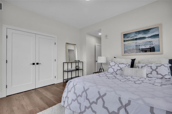 Bedroom featuring wood finished floors, a closet, and baseboards | Image 15