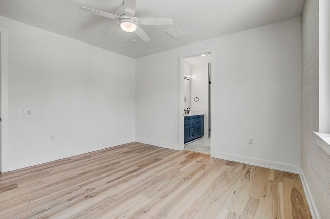 Empty room featuring a ceiling fan, light wood finished floors, and baseboards | Image 15