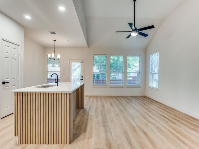 Kitchen featuring light wood-style flooring, ceiling fan, healthy amount of natural light, lofted ceiling, and recessed lighting | Image 8