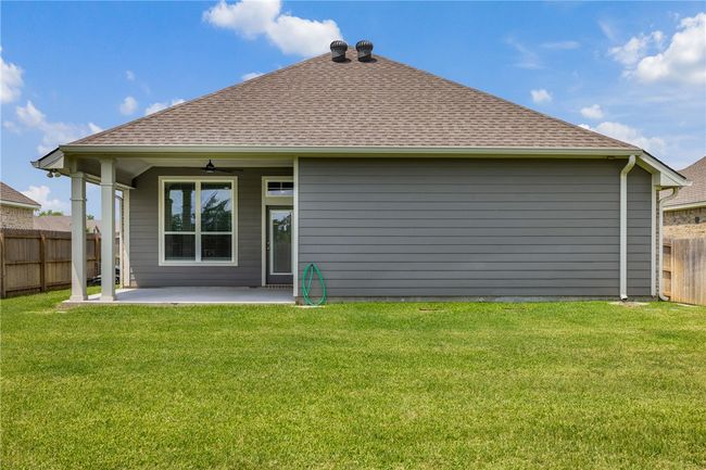 Back of property featuring a shingled roof, a patio, and a ceiling fan | Image 7