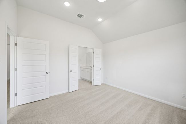 Unfurnished bedroom featuring lofted ceiling, light carpet, and recessed lighting | Image 22