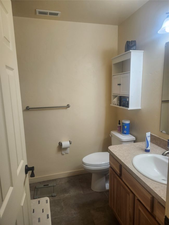 Bathroom featuring baseboards, visible vents, toilet, and vanity | Image 9