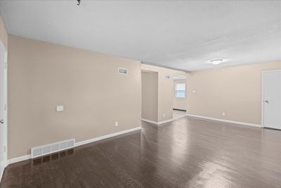 Unfurnished room with hardwood / wood-style flooring and a textured ceiling | Image 3