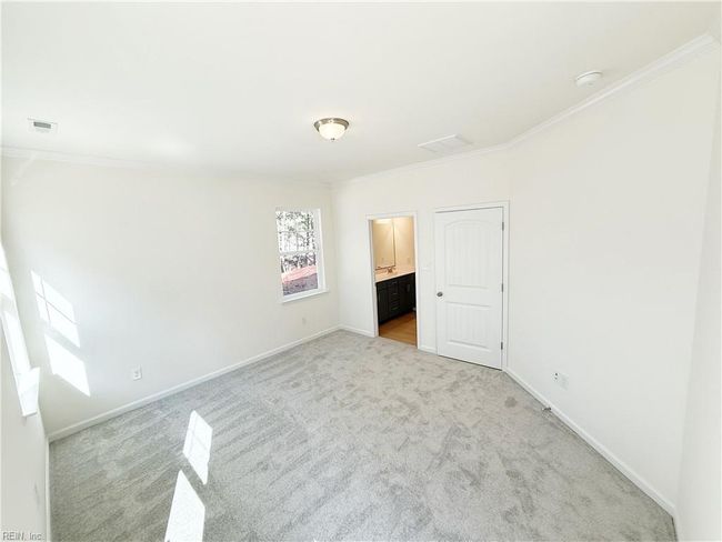 A first-floor primary suite features a walk-in closet and an ensuite bath with double vanity. | Image 7