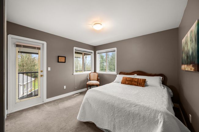 Bedroom with baseboards, multiple windows, carpet flooring, and access to outside | Image 29