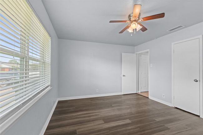 Unfurnished bedroom featuring wood finished floors and a ceiling fan | Image 16