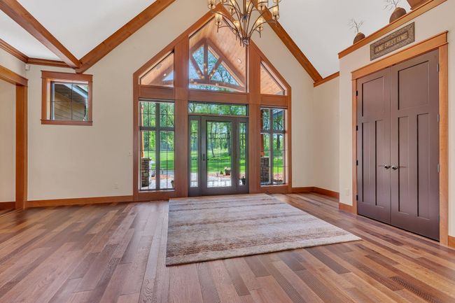 Vaulted grand entrance with abundant natural light streaming through large windows, creating a bright and welcoming atmosphere. | Image 27