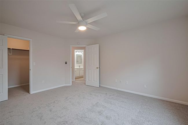 One of three secondary bedrooms upstairs, featuring closet space, all new carpet, freshly painted walls and ceiling, and a brand new ceiling fan for added comfort. | Image 31