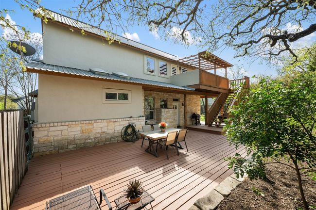 In the backyard, there are multiple places to relax and enjoy. The first is the large wooden deck. | Image 28