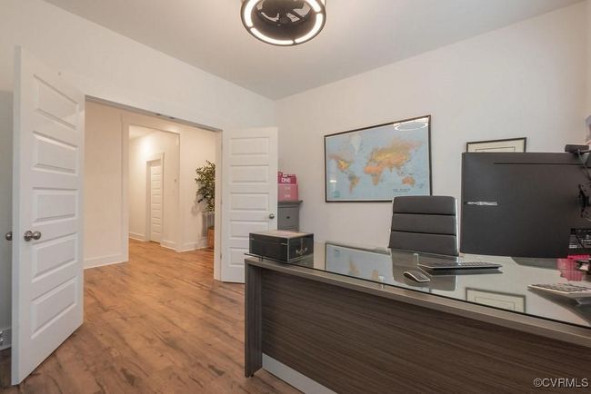 Office space with wood finished floors and baseboards | Image 13