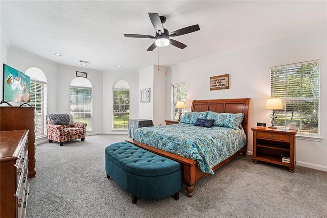 Expansive downstairs primary bedroom with bay window and extra seating area. | Image 17