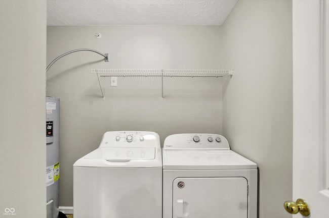 laundry room with washing machine and dryer | Image 31