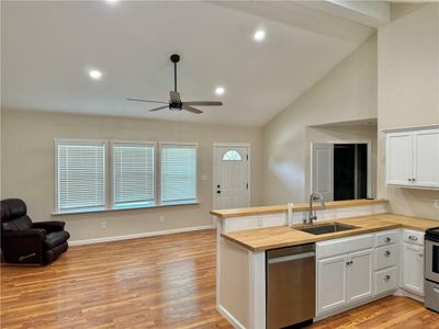 Kitchen featuring ceiling fan, wooden counters, stainless steel appliances, light wood-type flooring, and sink | Image 3