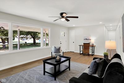 This house has tons of natural light that is filtered from the large shade trees and covered front porch. | Image 2