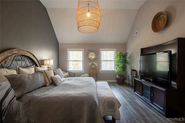 Bedroom featuring dark wood-type flooring, high vaulted ceiling, baseboards, and a chandelier | Image 36