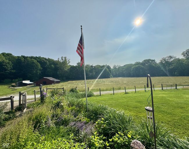 view of yard featuring a view of rural / pastoral area, an outdoor structure, and a view of trees | Image 10