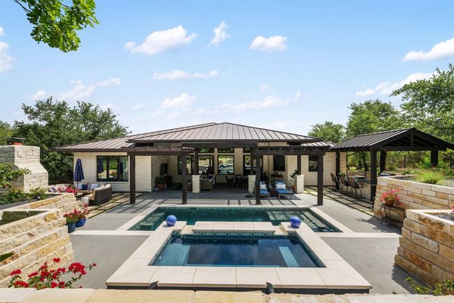 Swimming pool featuring a gazebo, a patio, an in-ground 10-person hot tub that is deep enough to stand in, and outdoor lounge area | Image 32