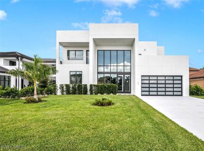 Modern home with a garage and a front lawn | Image 2