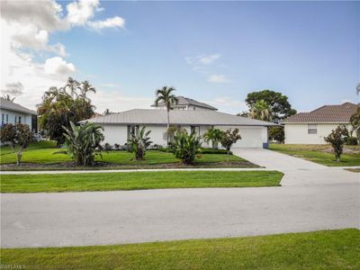 Single story home featuring a garage and a front lawn | Image 1