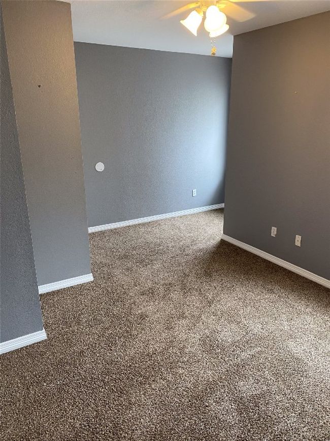 Carpeted spare room featuring baseboards and ceiling fan | Image 14