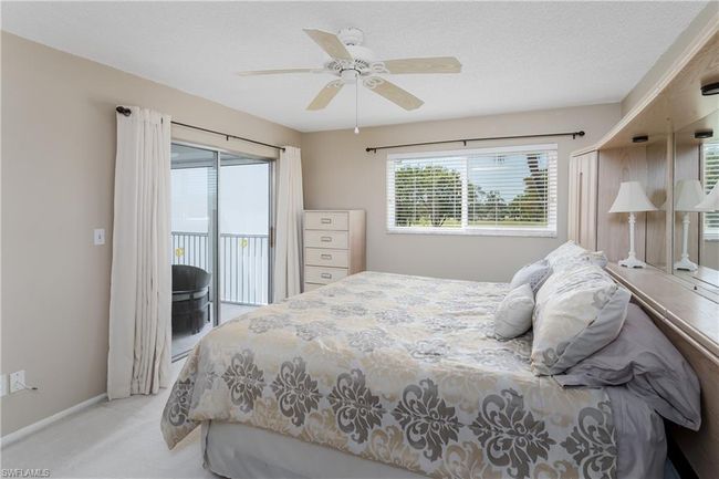 Carpeted bedroom with ceiling fan, baseboards, and access to outside | Image 11