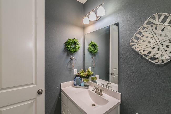 Bathroom featuring a textured wall and vanity | Image 22