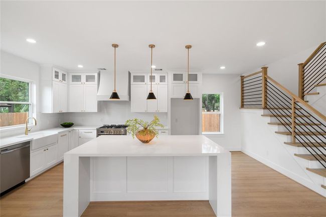 Quartz Counter Tops and island showcasing the waterfall edge | Image 8