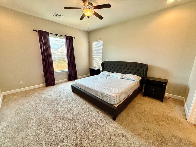 Carpeted bedroom with baseboards and ceiling fan | Image 8
