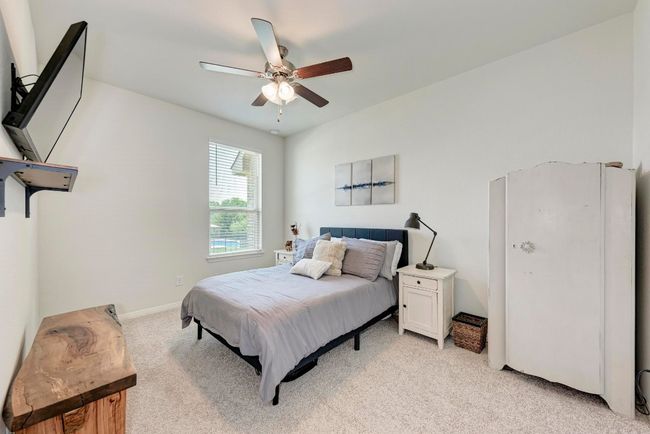 A third secondary bedroom is privacy situated, overlooking the side yard on the garage side. | Image 34