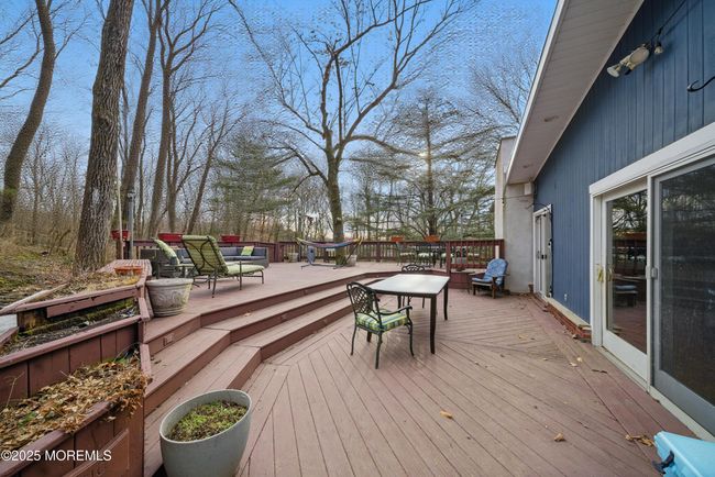 LARGE deck with privacy & nature with sliders to spacious living room & eat in Kitchen with separate Dining, Coffee bar, SS appliances and laundry room! | Image 15