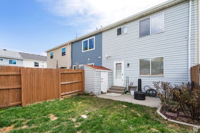 Back of house featuring a yard, a patio, entry steps, and a fenced backyard | Image 21
