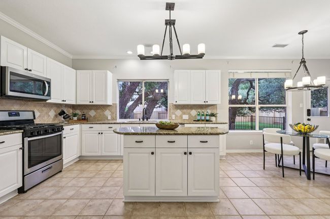 The heart of the home: an open-concept kitchen with ample cabinetry and prep space. | Image 17