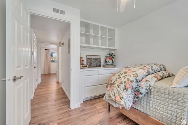 Bedroom featuring light wood-style floors and ceiling fan | Image 9