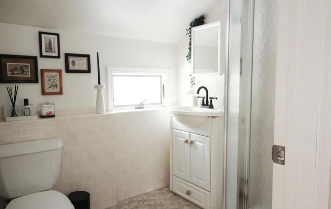 Bathroom featuring walk in shower, vanity, tile walls, tile patterned flooring, and toilet | Image 14
