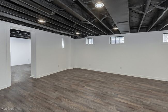 Basement with hardwood / wood-style floors and a healthy amount of sunlight | Image 40
