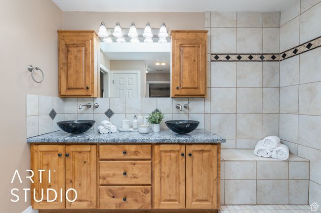Bathroom with double vanity, decorative backsplash, and a sink | Image 26