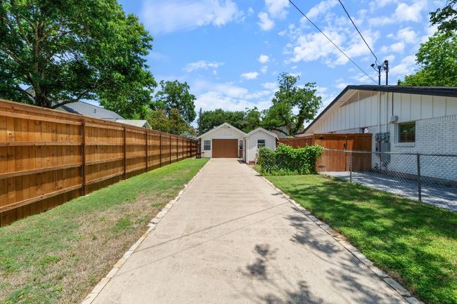 Fenced yard with an outdoor structure and a garage | Image 32