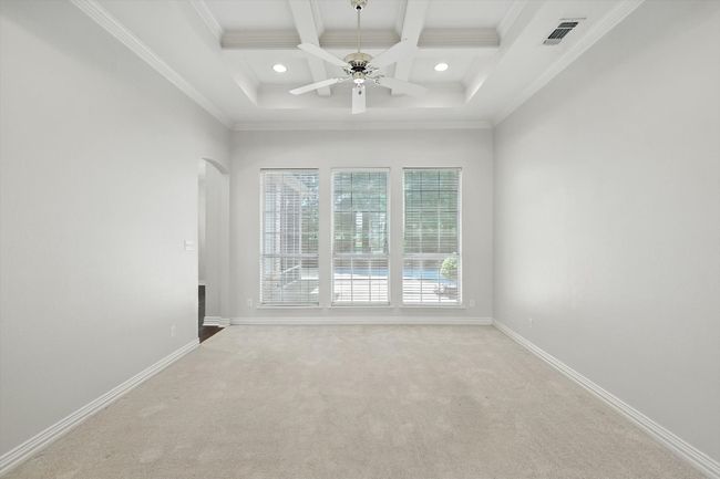 Carpeted spare room featuring coffered ceiling, beam ceiling, arched walkways, recessed lighting, and ornamental molding | Image 4