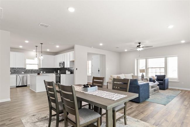 Dining room featuring light wood-type flooring, a ceiling fan, recessed lighting, and visible vents | Image 12